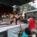 Tina Turner Tribute Artist, Luisa Marshall guitar player Kim Mendez gives a high five to some young fans.