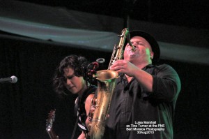 Guitarist Kim Mendez and Sax player Bob Tarr on stage with Tina Turner Tribute Impersonator, Luisa Marshall at the Chevrolet Performance Stage at the PNE.