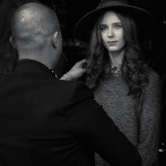 Gian Carlo adds some finishing touches to model at Vancouver Fashion Week.