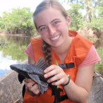 Becky Friesen holding a "some sort of ancient Amazonian fish" during her research trip in Peru.